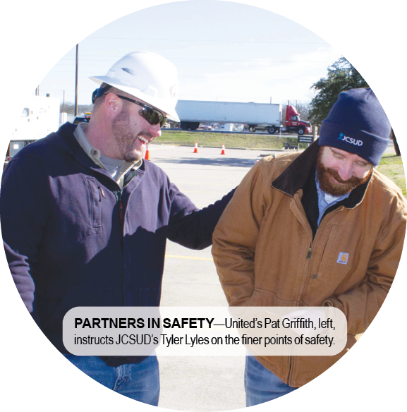 PARTNERS IN SAFETY—United’s Pat Griffith, left, instructs JCSUD’s Tyler Lyles on the finer points of safety. 