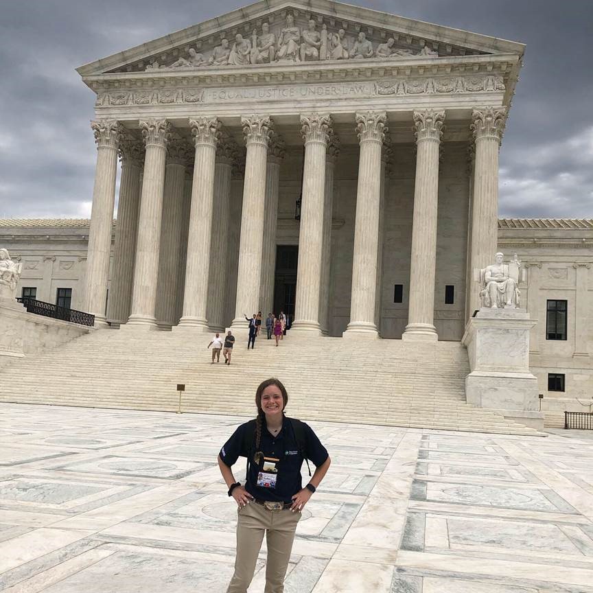 Sydney Aalbers stands in front of the Supreme Court's facade. 