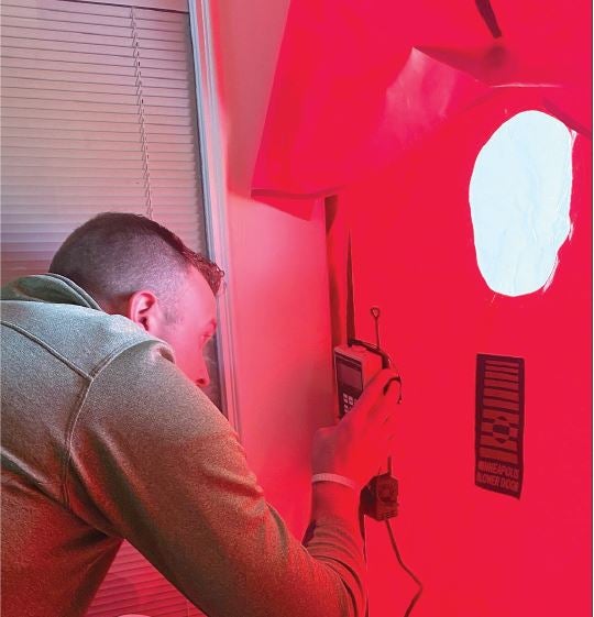 United’s Kanyon Payne performs a blower-door test.