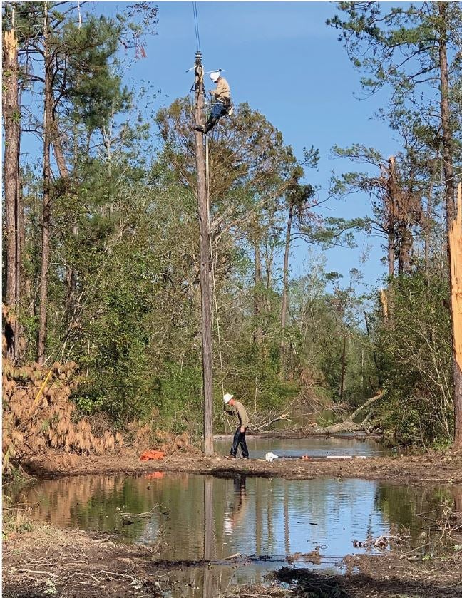 Linemen battled flooding as they tried restoring power following Hurricane Delta in Louisiana.