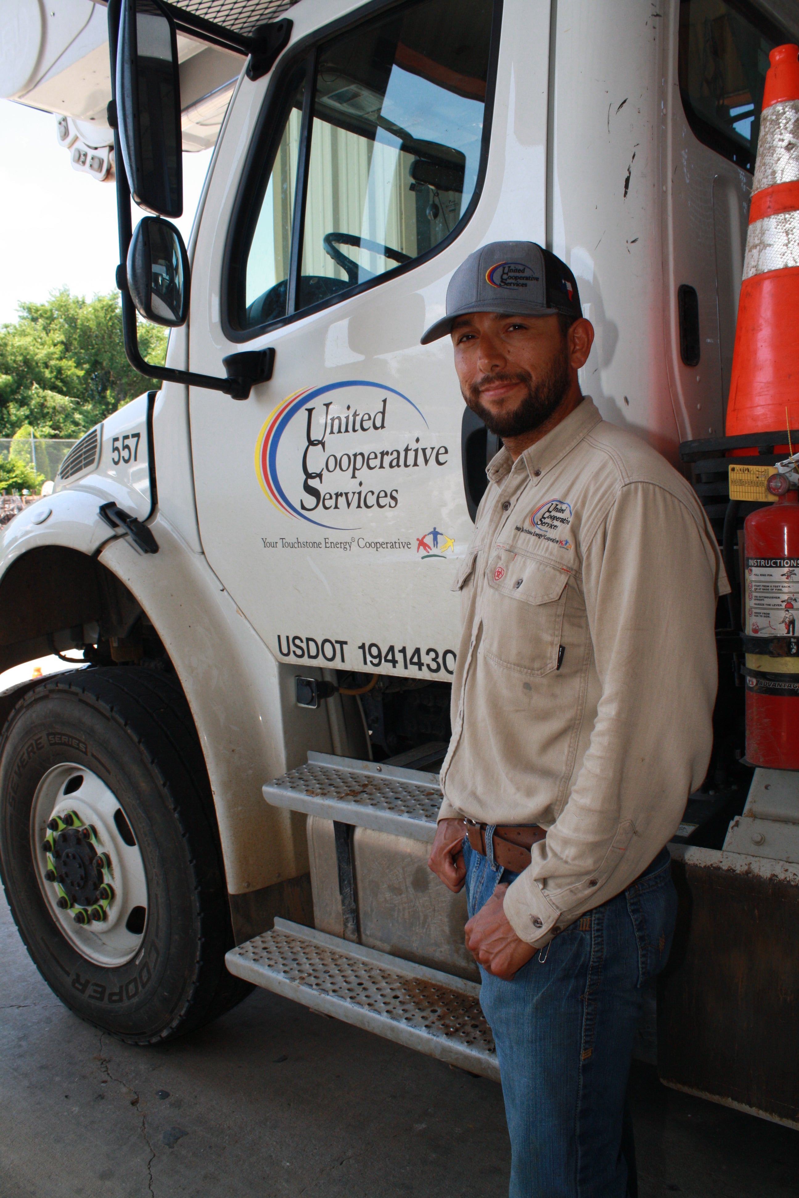 Image of United lineman leaning against truck