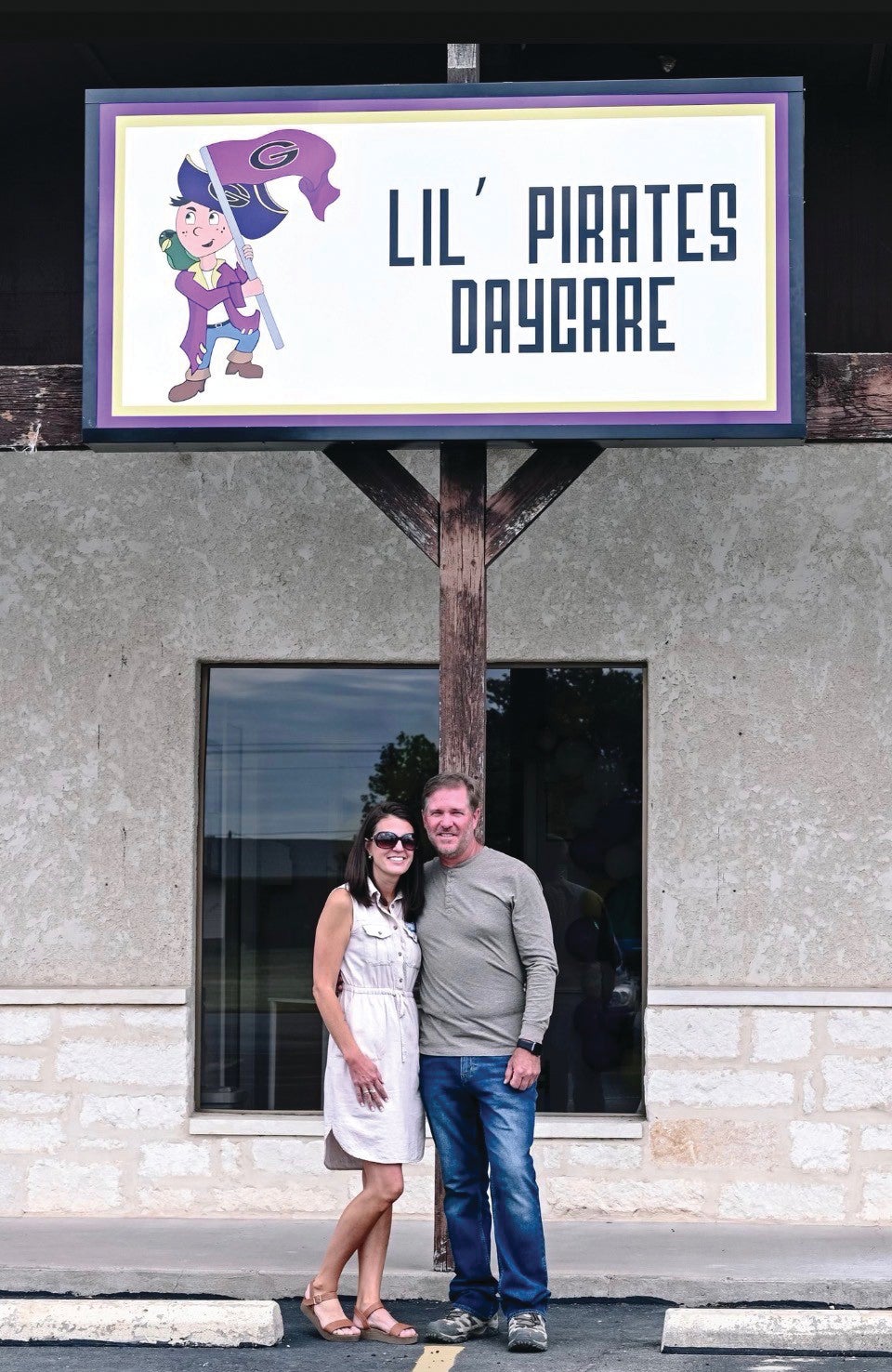 Man and woman standing outside in front of daycare