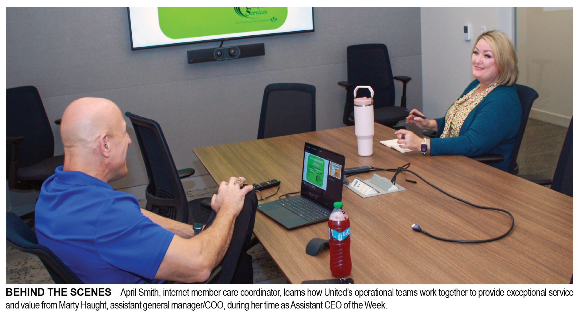 image of two people at a conference table meeting