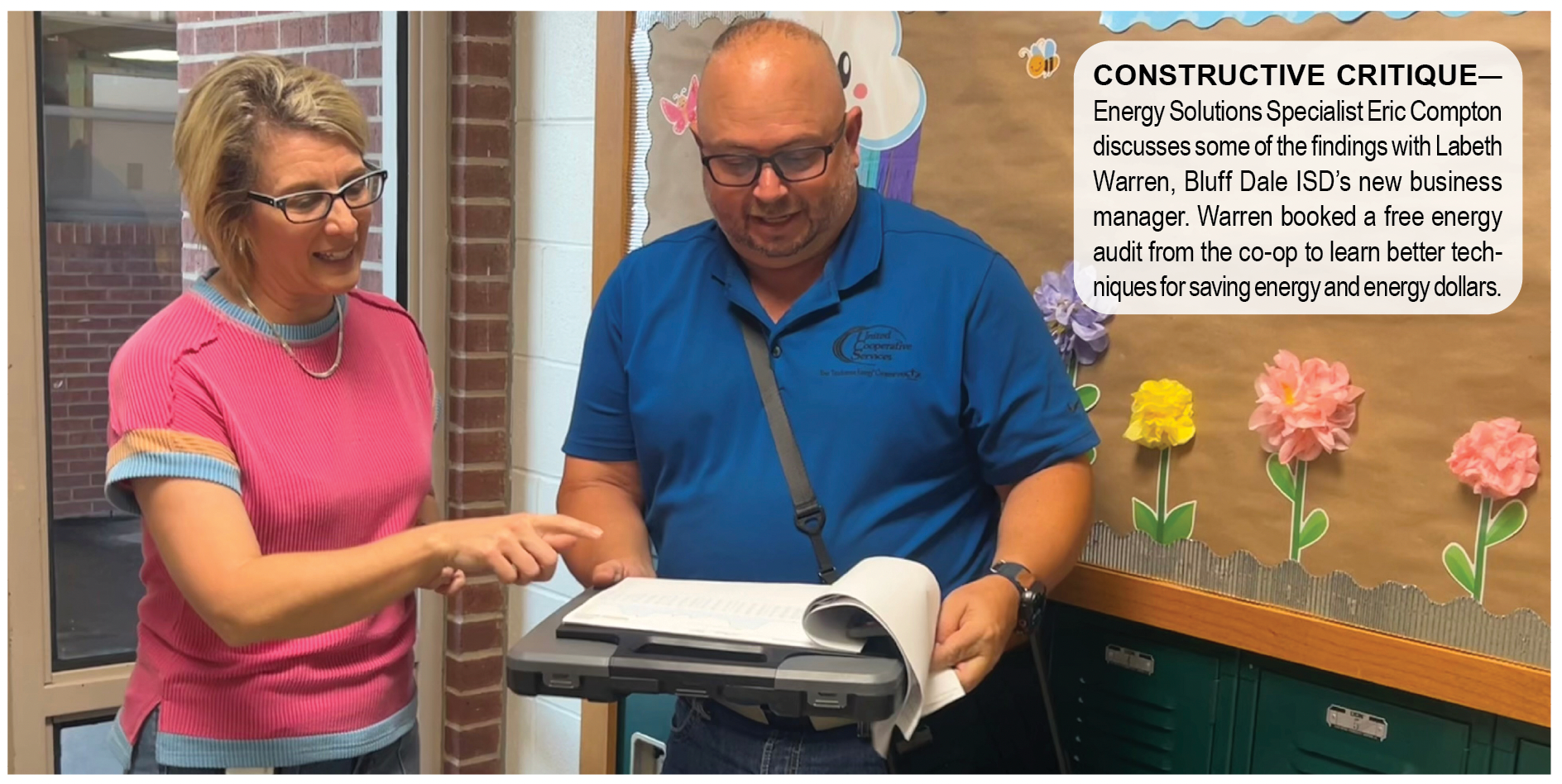 IMAGE OF TWO PEOPLE LOOKING AT A CLIPBOARD
