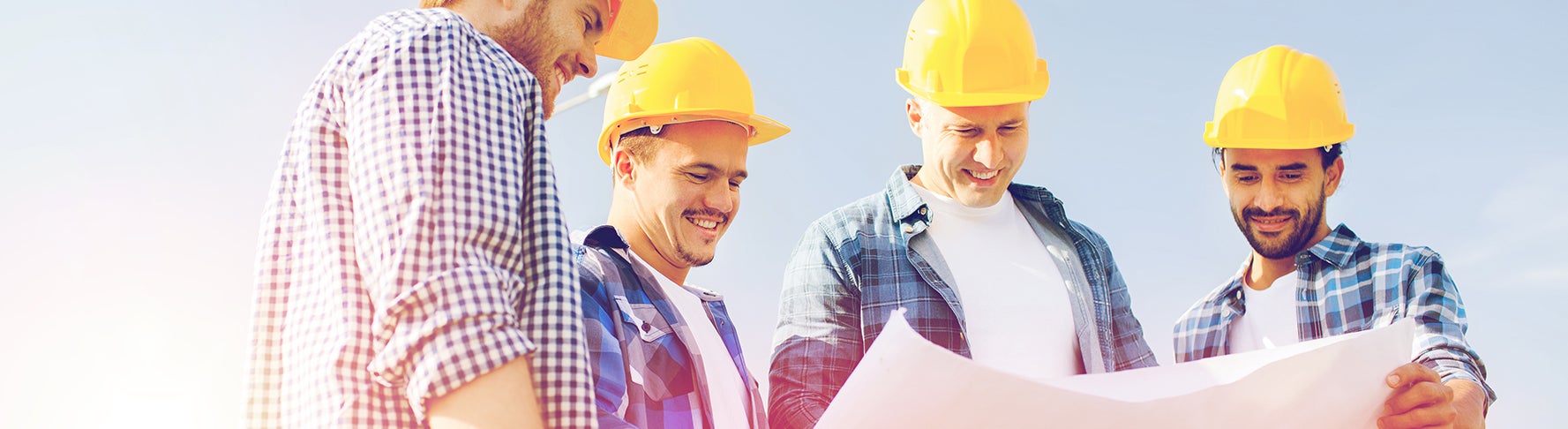 Men standing around a contsruction site.