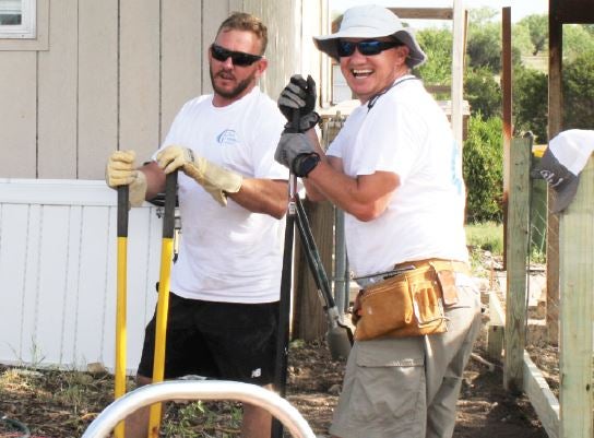 Brody Weems and Jeff Pannell work together to build a ramp for a member’s home.