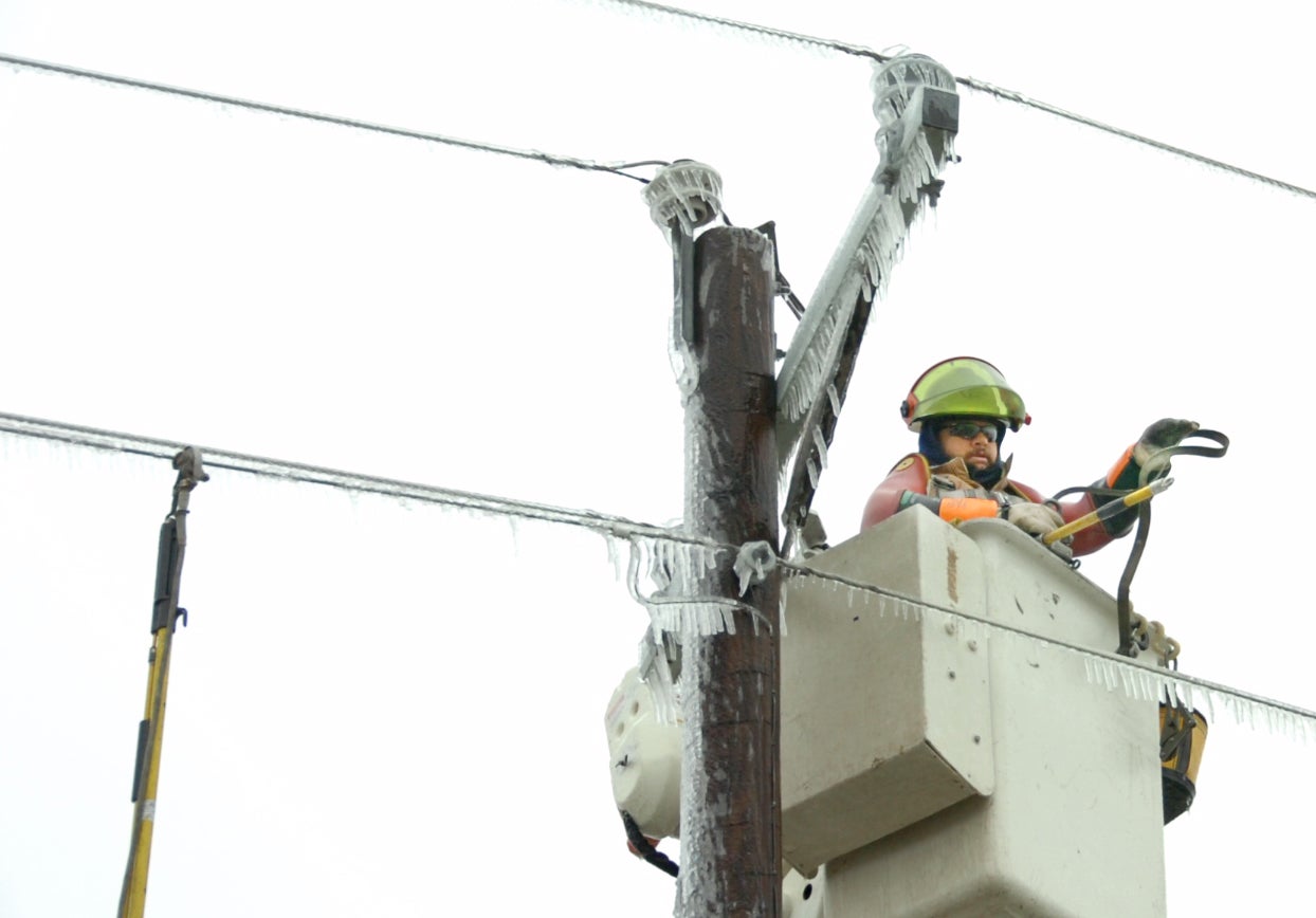 Lineman on icy pole