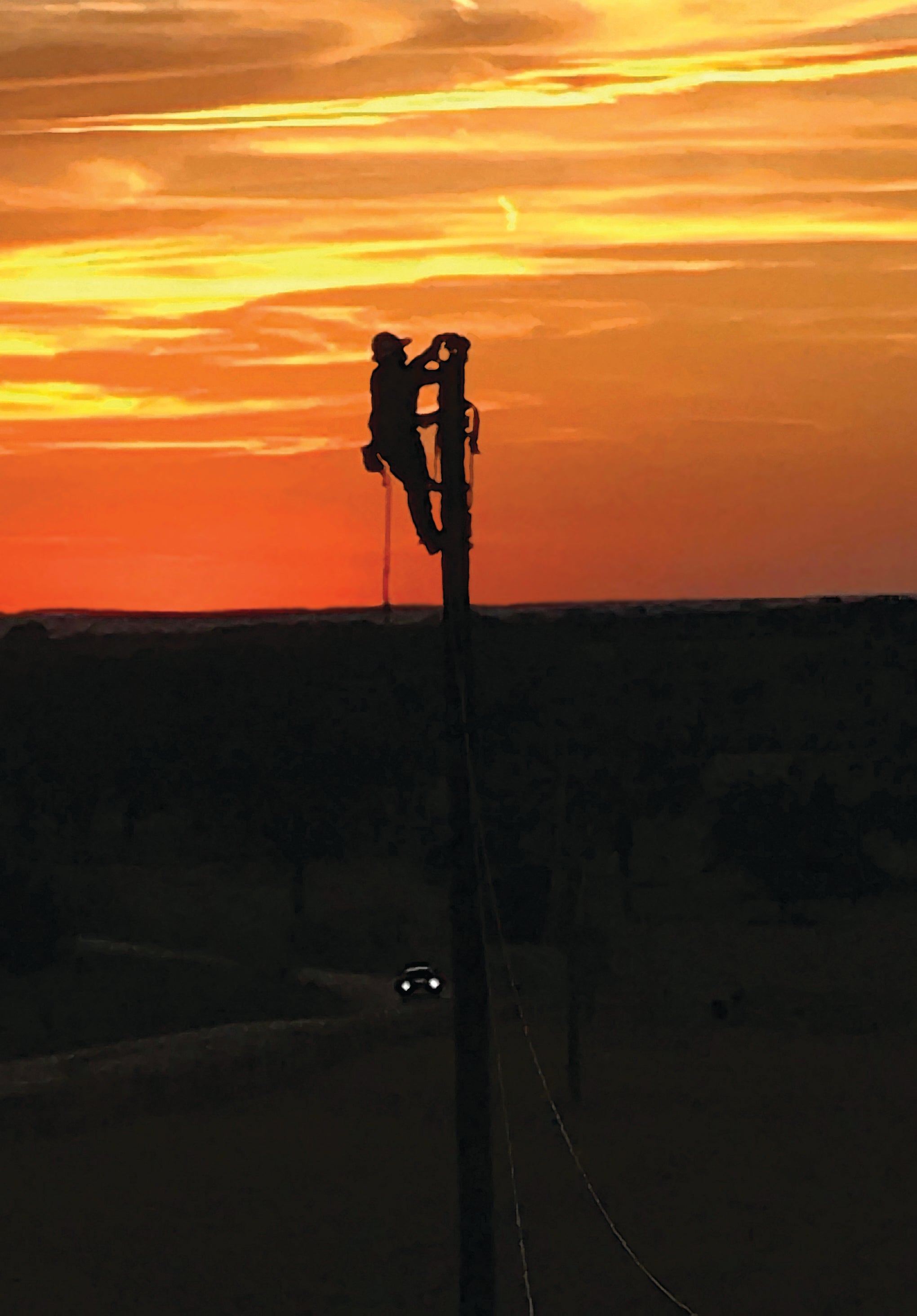 Lineman on a pole at Sunrise