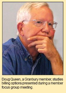 Doug Queen, a Granbury member, studies  billing options presented during a member focus group meeting.