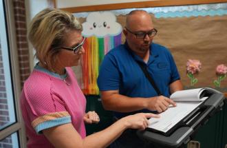 Image of two people looking at a clipboard