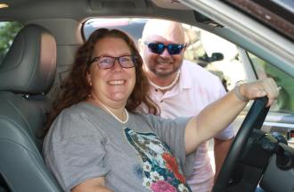 Image of man and woman in hybrid vehicle