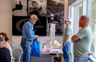 Three men talking at check in