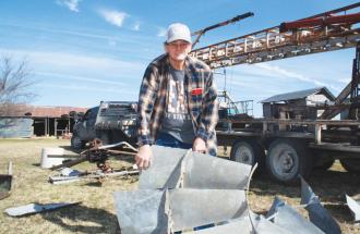 image of man holding windmill parts
