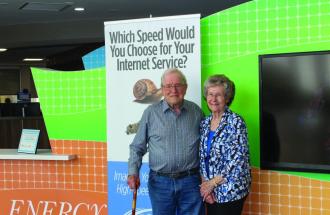 Man and woman standing in front of internet sign