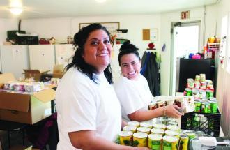 Image of two ladies packing groceries