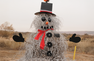 Straw snowman in dry field. 