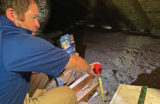 Inspecting attic.
