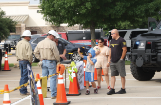 Jacob Pierce waves goodbye after watching United’s arcing demonstration with his parents at Super Safety Saturday.